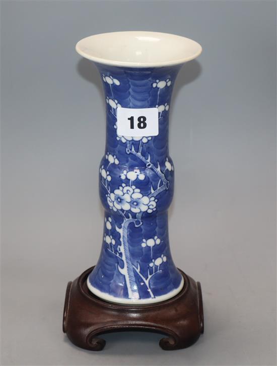 A Chinese blue and white prunus beaker vase, 19th century, wood stand height 20cm excluding stand